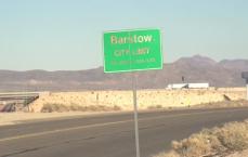 Barstow sign with car driving by