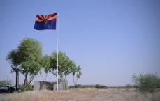 Arizona flag waving in the wind with a clear blue sky